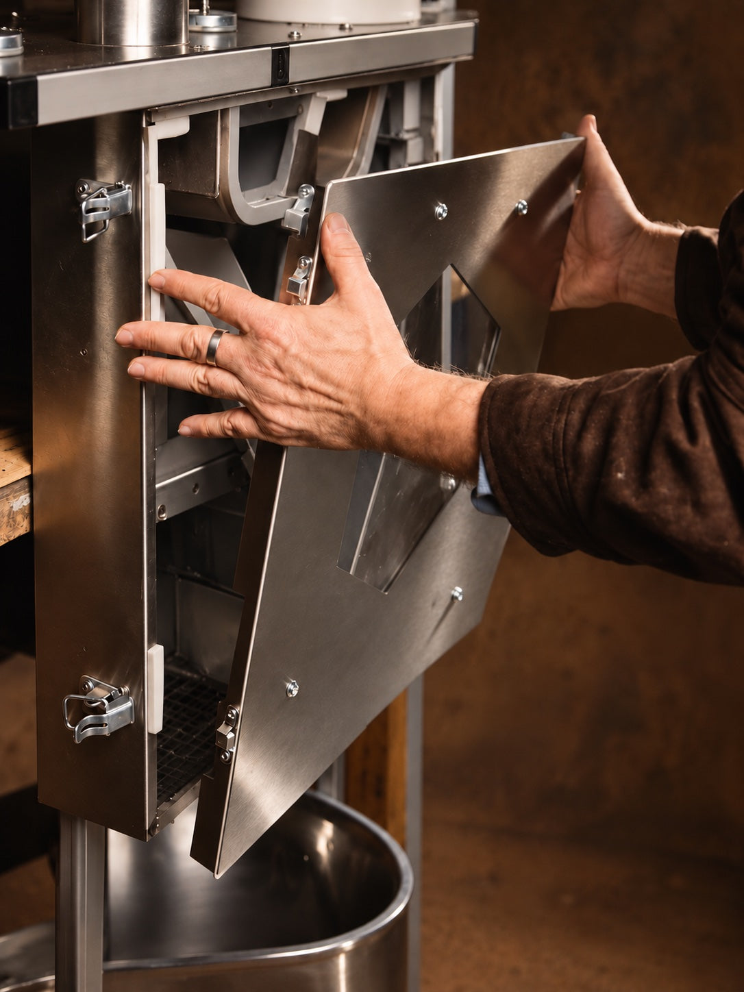 Hands removing the Flux chamber cover for access and cleaning